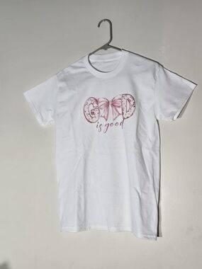 White 'God is Good' Short Sleeve Tee with Pink Script. Size S.